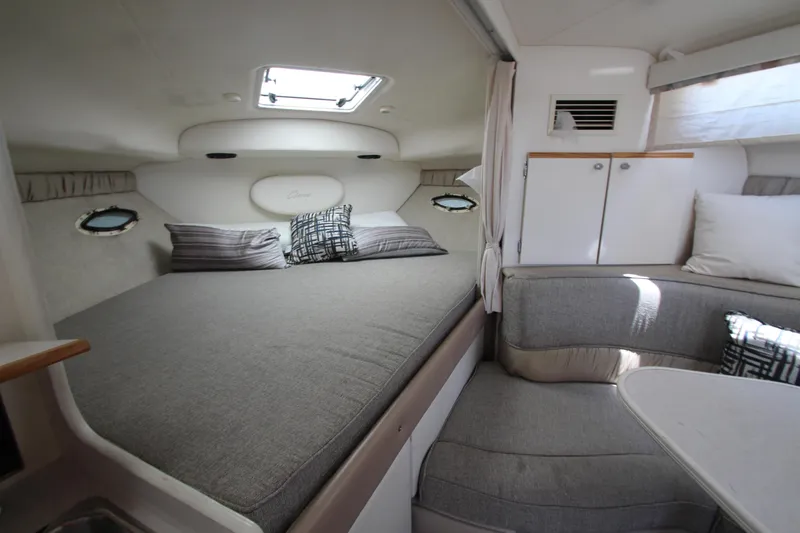 Slide: The Image of 1999 Bayliner 3055 Ciera cabin interior with bed, seating, and storage. - 18