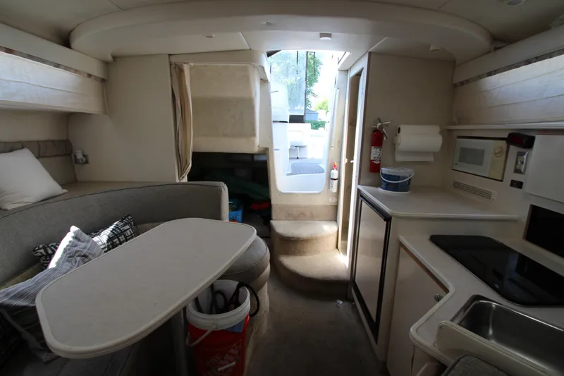 Slide: The Image of Interior of 1999 Bayliner 3055 Ciera boat with kitchenette and seating area. - 19