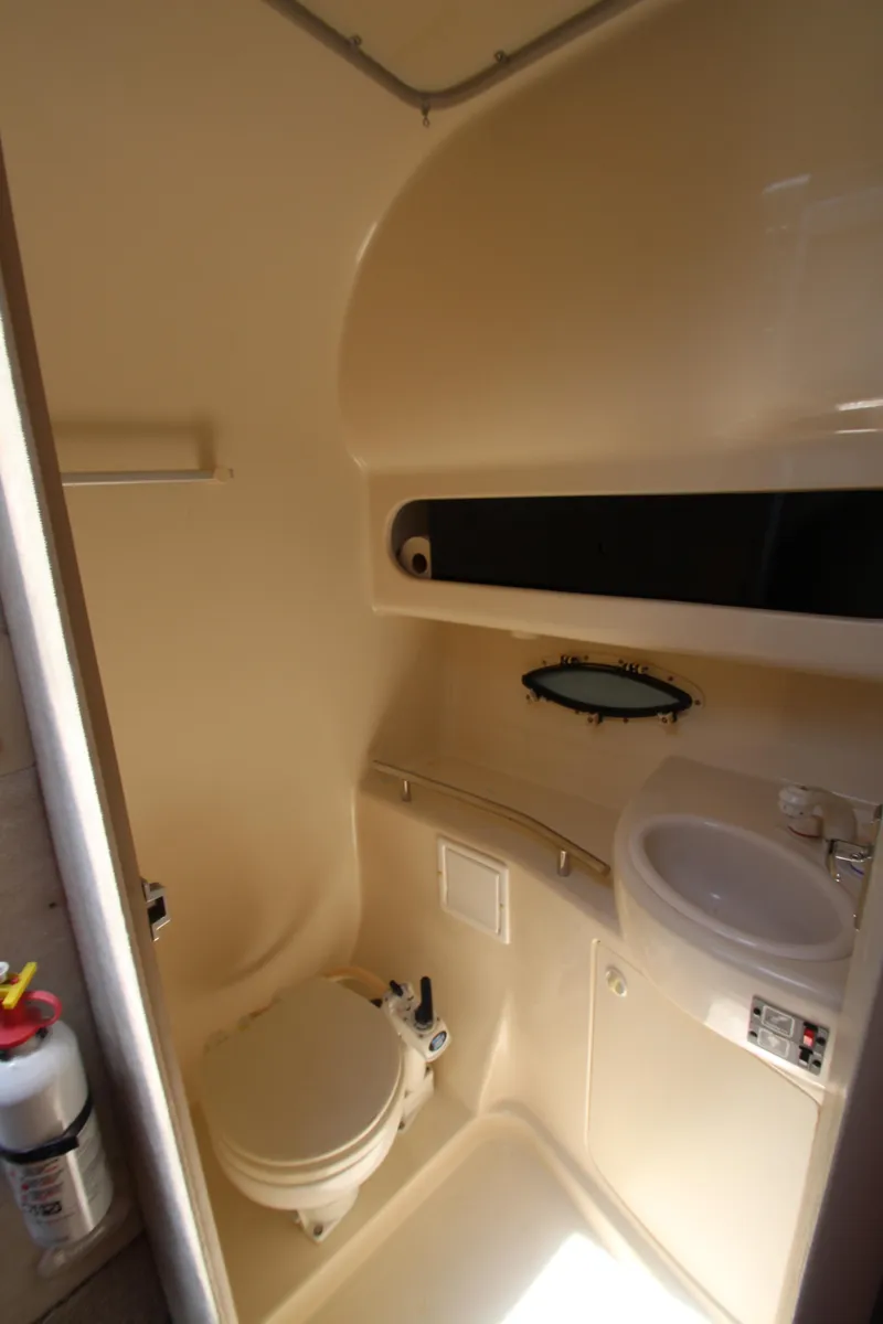 Slide: The Image of 1999 Bayliner 3055 Ciera boat bathroom with toilet, sink, and storage. - 21