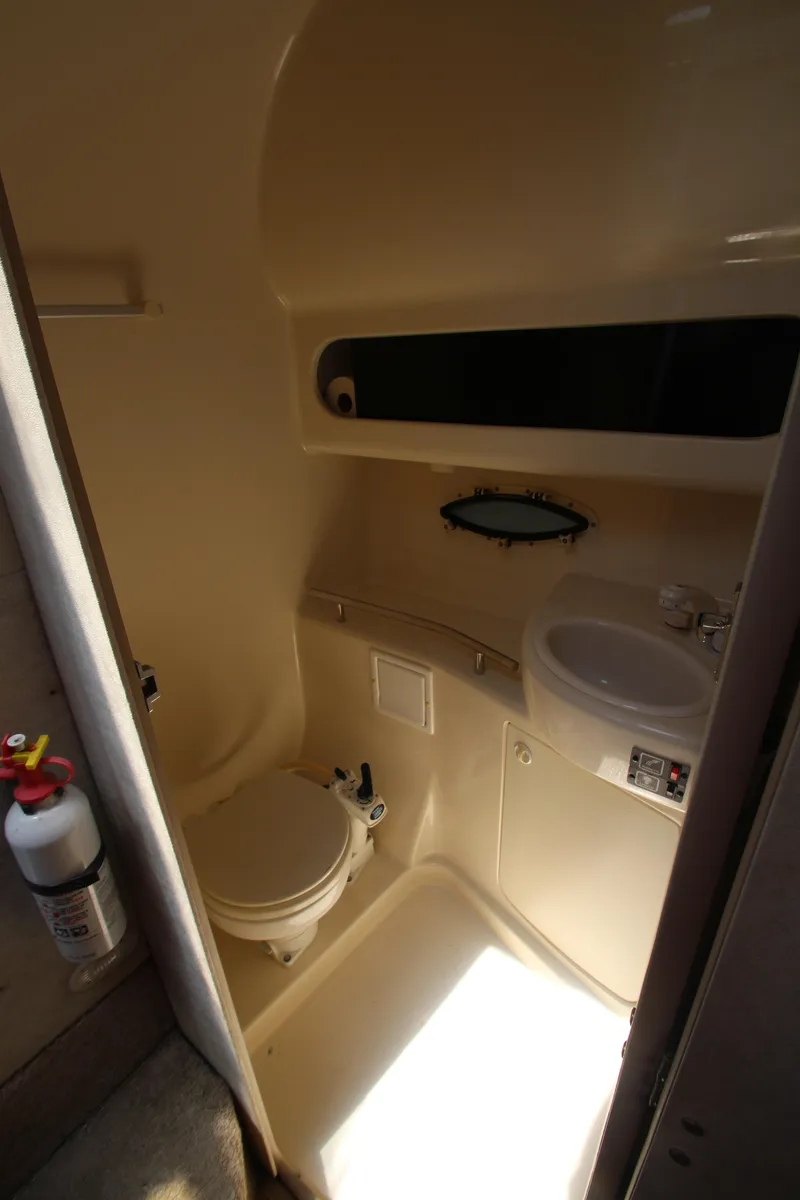 Slide: The Image of 1999 Bayliner 3055 Ciera boat bathroom with toilet, sink, and storage. - 22