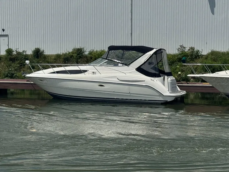 Slide: The Image of 1999 Bayliner 3055 Ciera boat docked on calm water near a marina. - 25
