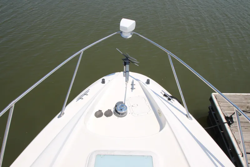 Slide: The Image of Bow view of 1999 Bayliner 3055 Ciera boat docked on calm water. - 4