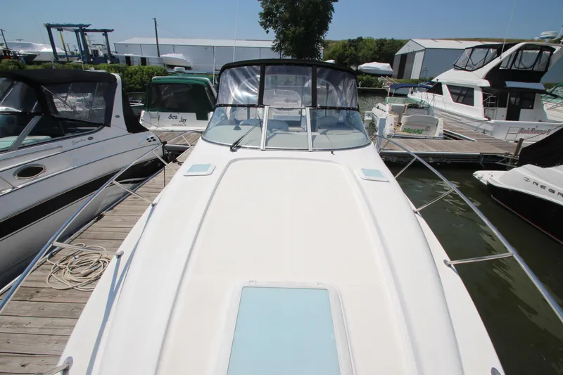 Slide: The Image of 1999 Bayliner 3055 Ciera docked at marina, surrounded by other boats. - 5