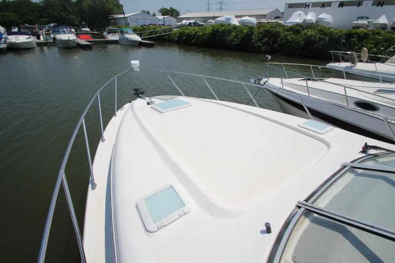 Slide: The Image of 1999 Bayliner 3055 Ciera boat docked at marina, surrounded by other boats. - 6