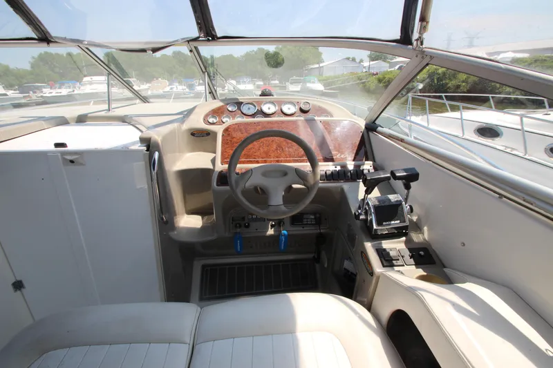 Slide: The Image of 1999 Bayliner 3055 Ciera boat cockpit with steering wheel and control panel. - 9