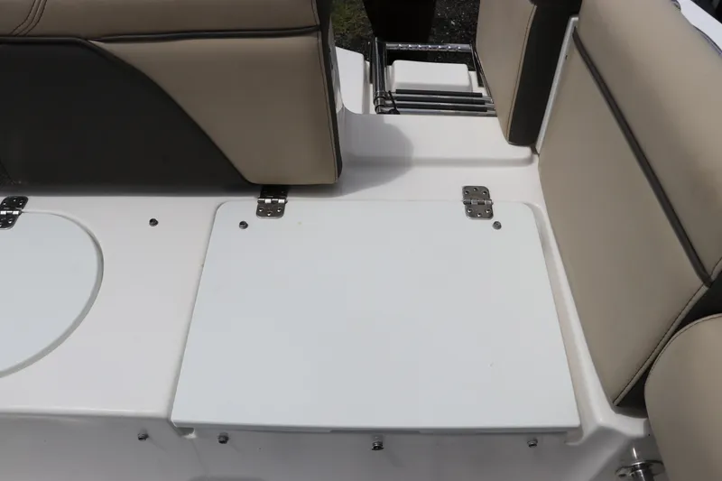 Slide: The Image of 2022 Tidewater 232 SS boat seating area with beige and black upholstery. - 11