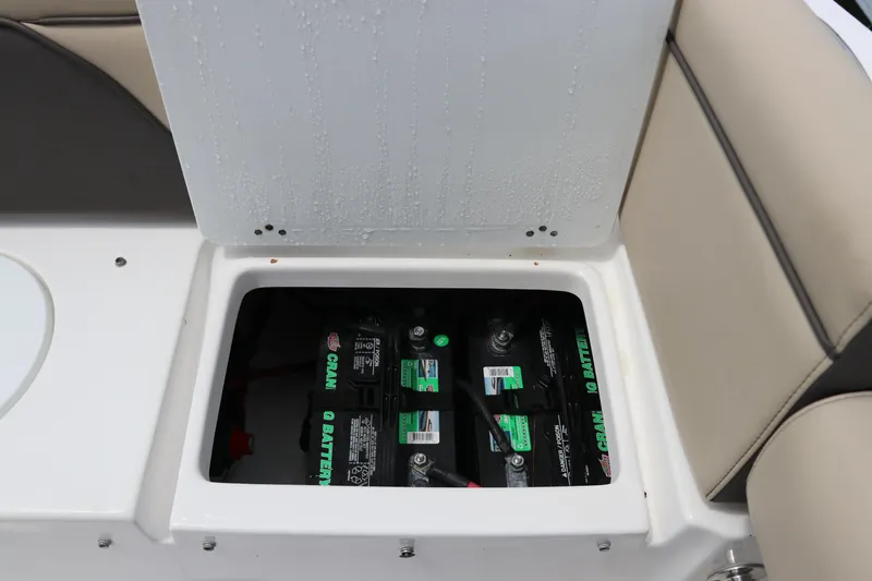 Slide: The Image of 2022 Tidewater 232 SS boat battery compartment with visible batteries. - 12