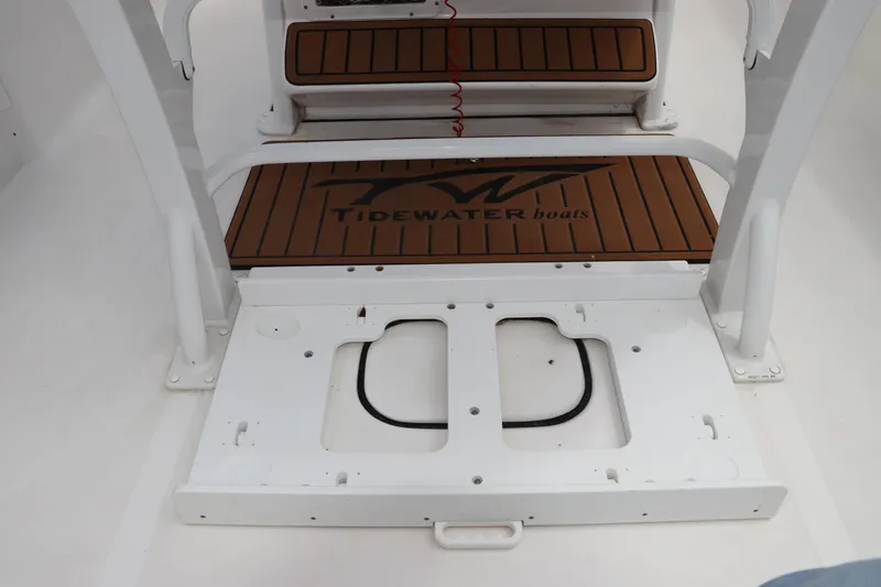 Slide: The Image of 2022 Tidewater 232 SS boat interior with brown deck and white frame. - 15
