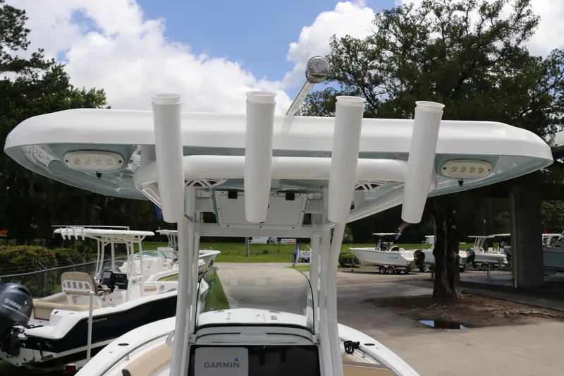 Slide: The Image of 2022 Tidewater 232 SS boat with T-top and rod holders, parked outdoors. - 17