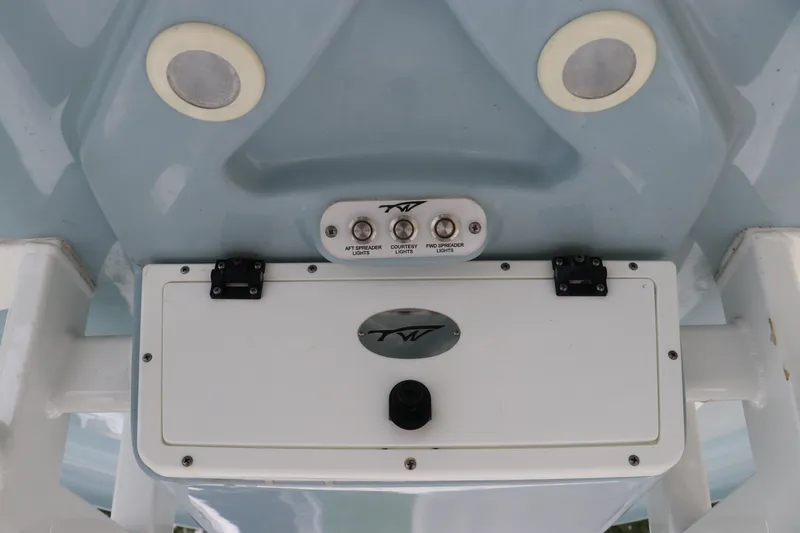 Slide: The Image of 2022 Tidewater 232 SS boat controls and lights on light blue hull. - 19