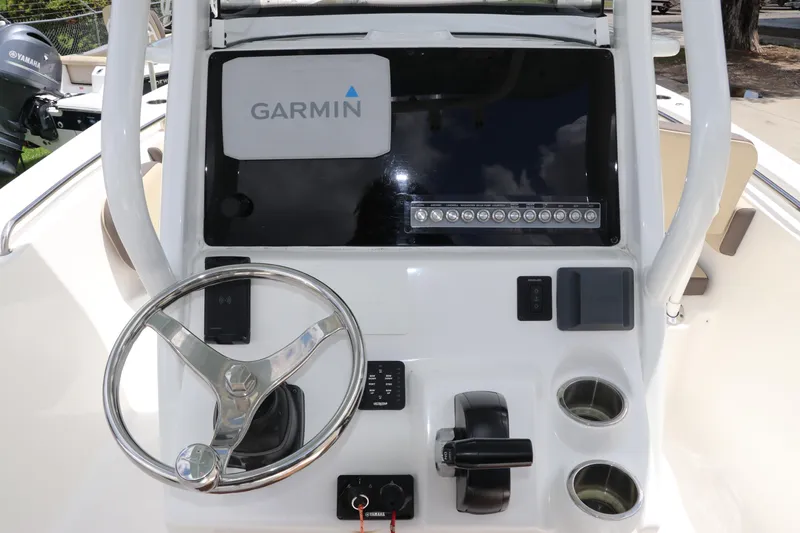 Slide: The Image of 2022 Tidewater 232 SS boat dashboard with Garmin display and steering wheel. - 20