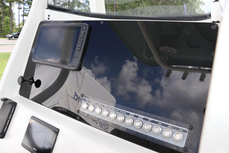 Slide: The Image of 2022 Tidewater 232 SS boat dashboard with Garmin display and control panel. - 21