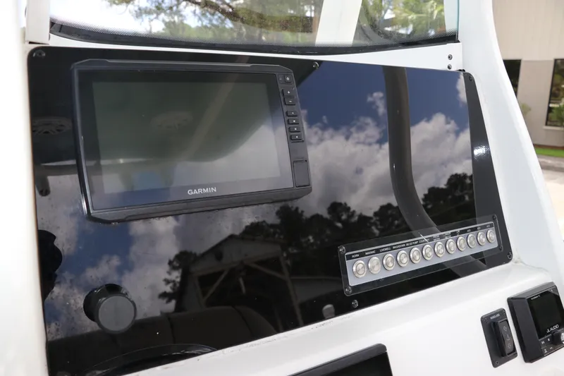 Slide: The Image of 2022 Tidewater 232 SS boat dashboard with Garmin display and control panel. - 22