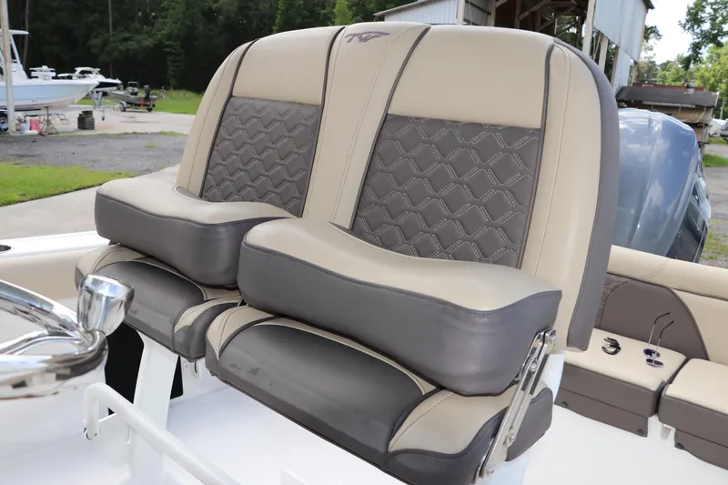 Slide: The Image of 2022 Tidewater 232 SS boat seats with beige and gray upholstery, featuring a stylish design. - 27