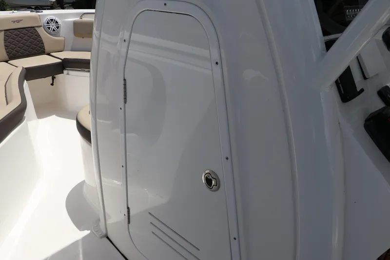Slide: The Image of 2022 Tidewater 232 SS boat interior with seating and storage compartment. - 31
