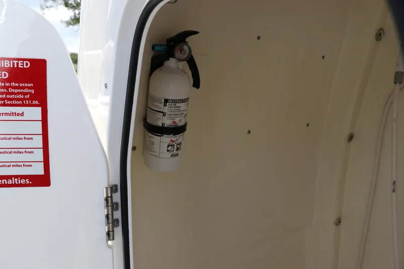 Slide: The Image of Fire extinguisher inside 2022 Tidewater 232 SS boat compartment. - 32