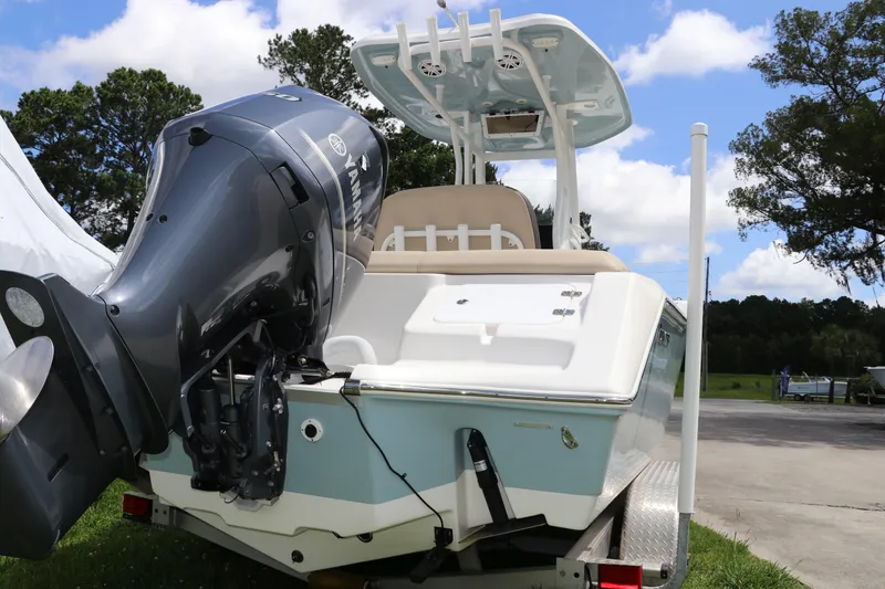 Slide: The Image of 2022 Tidewater 232 SS boat with Yamaha outboard motor on trailer, parked outdoors. - 4