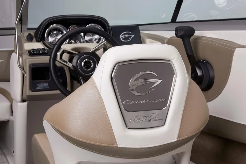 Slide: The Image of 2025 Crownline 220 SS boat interior with steering wheel and branded seat. - 4