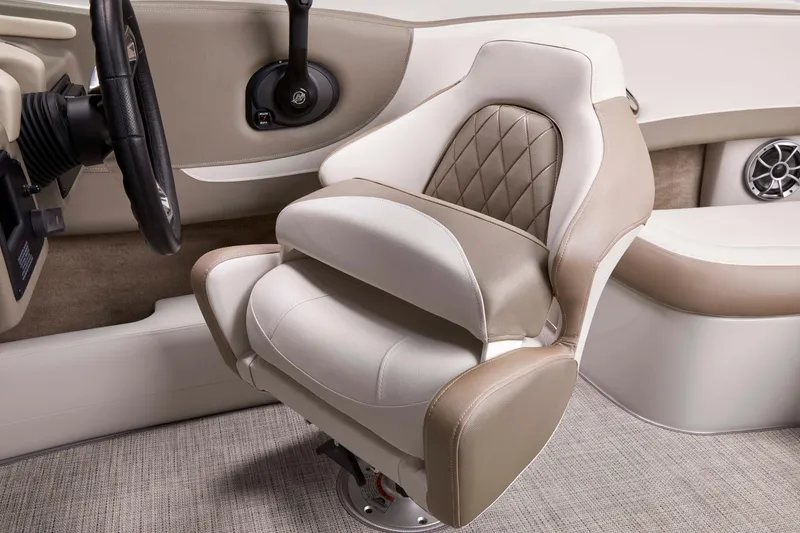 Slide: The Image of Captain's seat in 2025 Crownline 220 SS boat, featuring luxurious beige and white upholstery. - 8