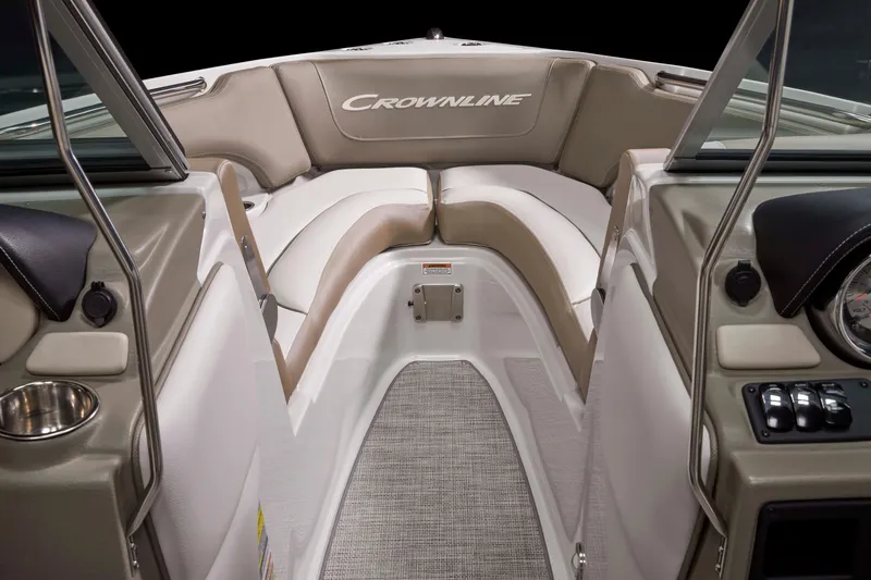 Slide: The Image of 2025 Crownline 220 SS boat interior with beige seating and modern dashboard. - 9