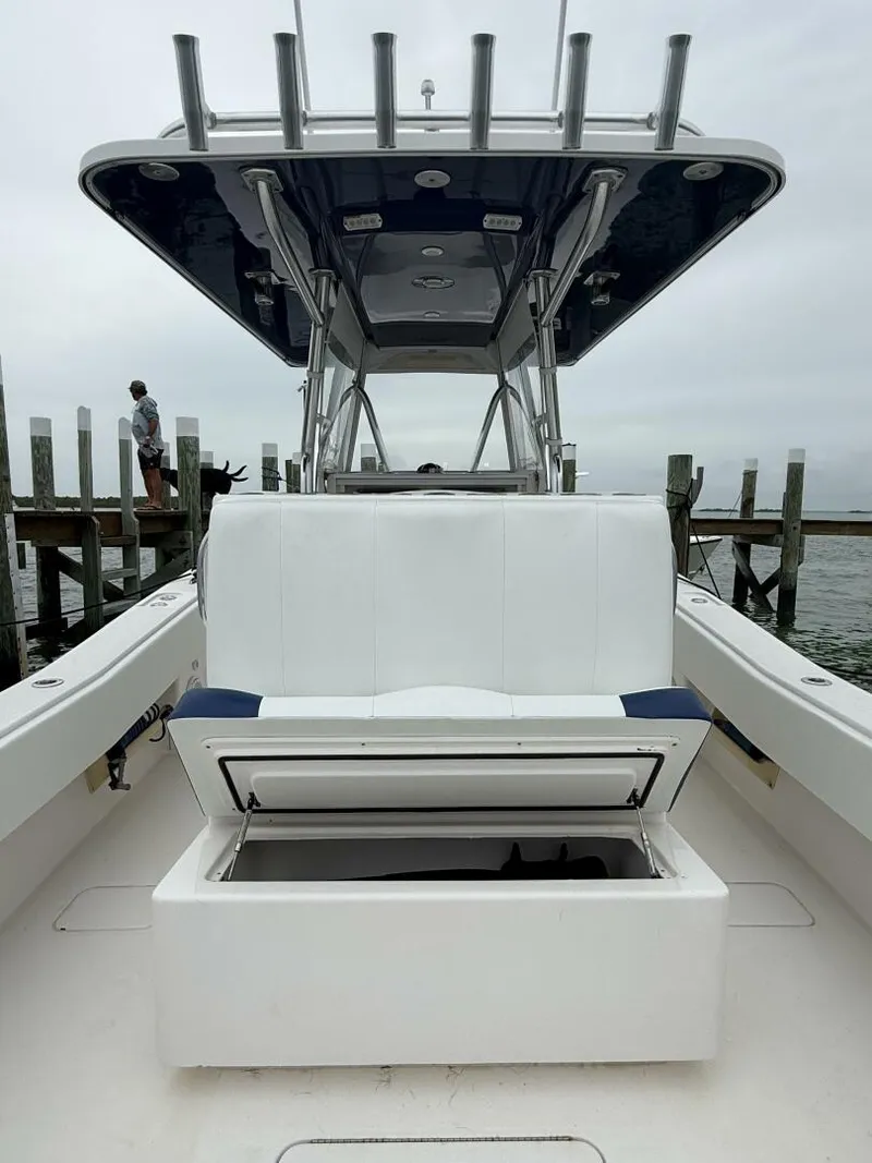 Slide: The Image of 2012 Invincible 36 Open Fisherman boat with open storage, docked by the water. - 10