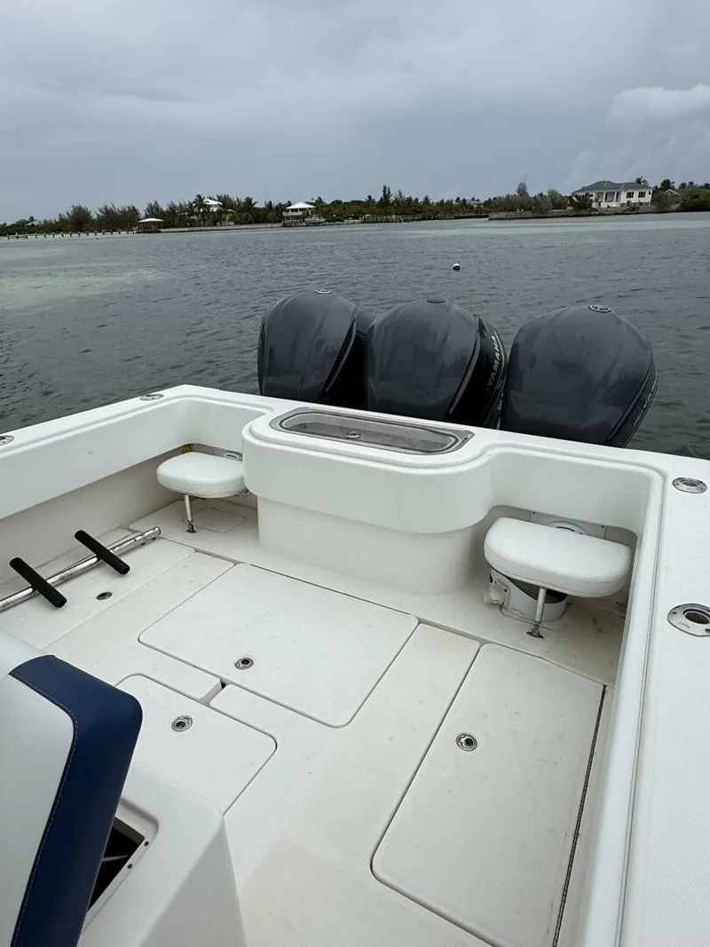 Slide: The Image of 2012 Invincible 36 Open Fisherman boat with triple engines on calm water. - 11