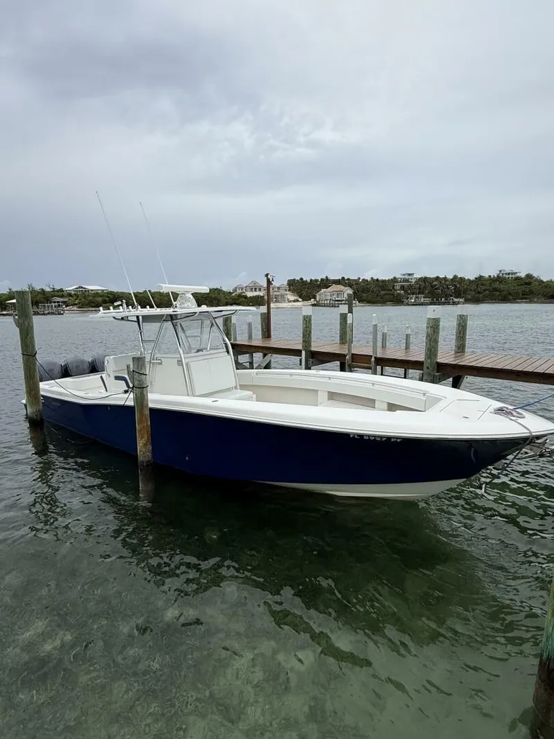 Slide: The Image of 2012 Invincible 36 Open Fisherman boat docked in calm waters. - 13