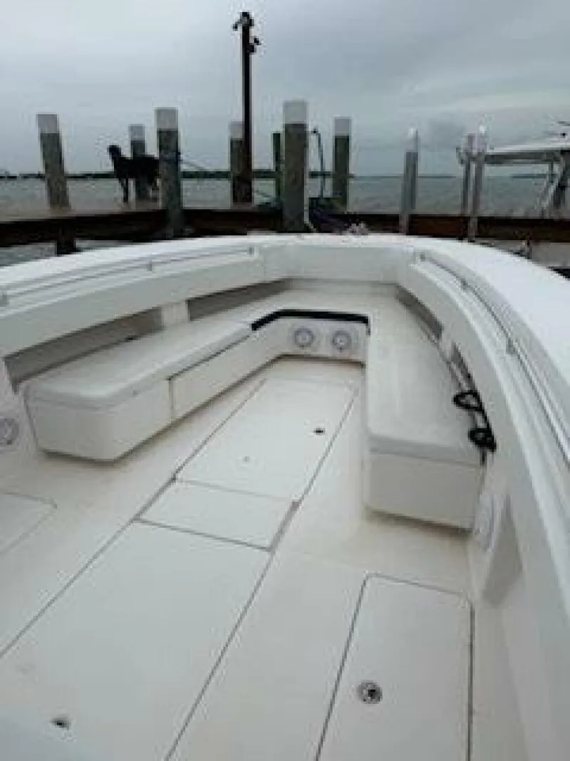 Slide: The Image of 2012 Invincible 36 Open Fisherman boat interior with seating, dockside view. - 3