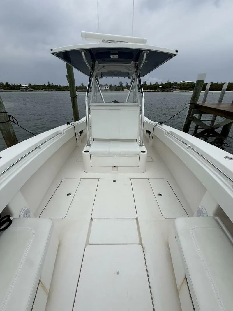 Slide: The Image of 2012 Invincible 36 Open Fisherman boat docked, showcasing spacious deck and seating. - 4