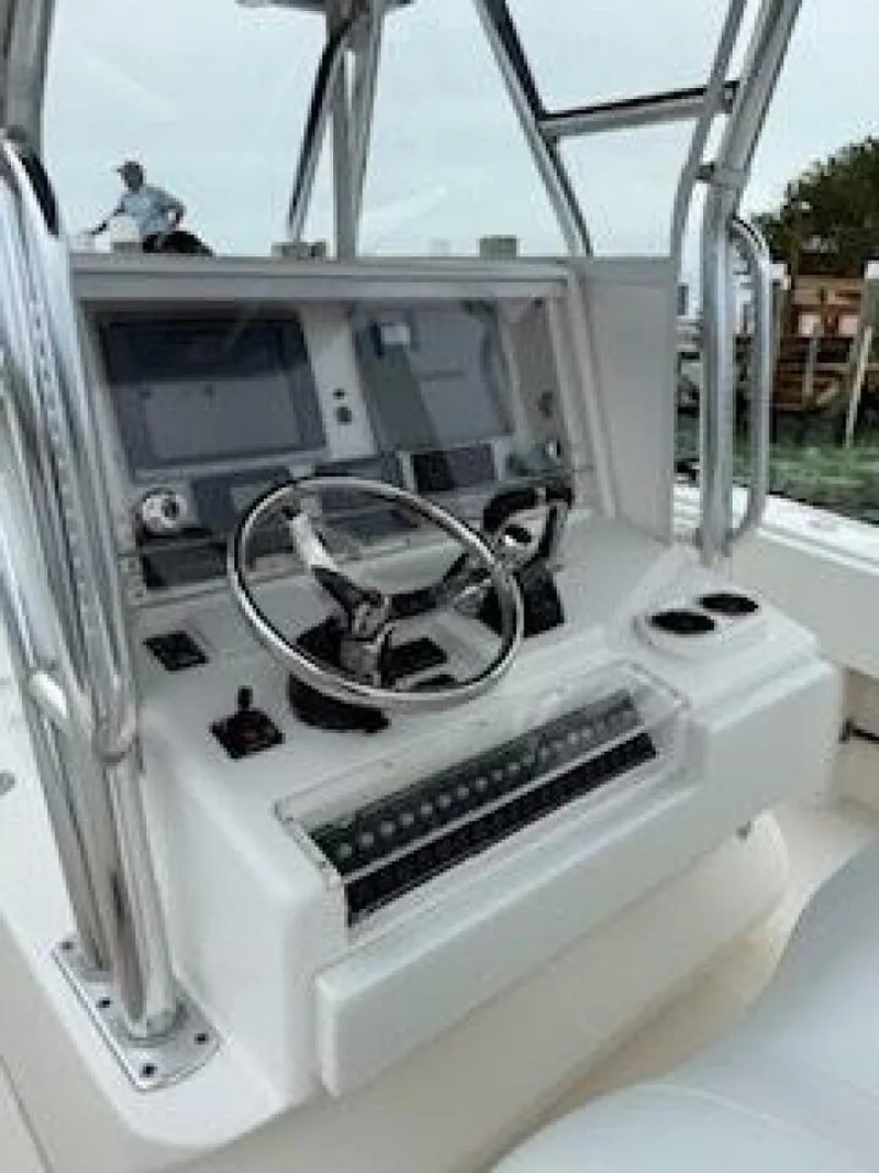 Slide: The Image of Control console of a 2012 Invincible 36 Open Fisherman boat with steering wheel and displays. - 7
