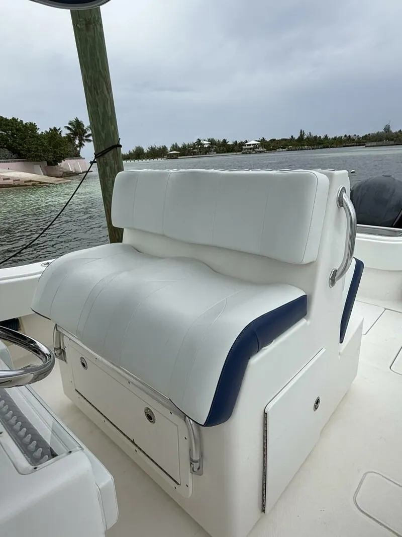 Slide: The Image of White cushioned seat on 2012 Invincible 36 Open Fisherman boat, docked by calm waters. - 9