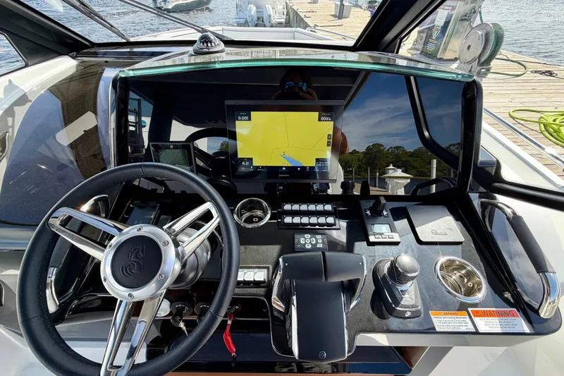 Slide: The Image of Helm of 2026 Beneteau Gran Turismo 35 with advanced navigation controls and steering wheel. - 21