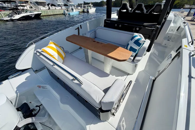 Slide: The Image of 2026 Beneteau Gran Turismo 35 yacht interior with seating, table, and decorative pillows. - 24