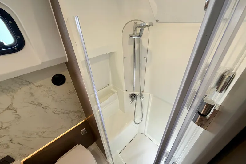 Slide: The Image of 2026 Beneteau Gran Turismo 35 yacht bathroom with modern shower and marble accents. - 26