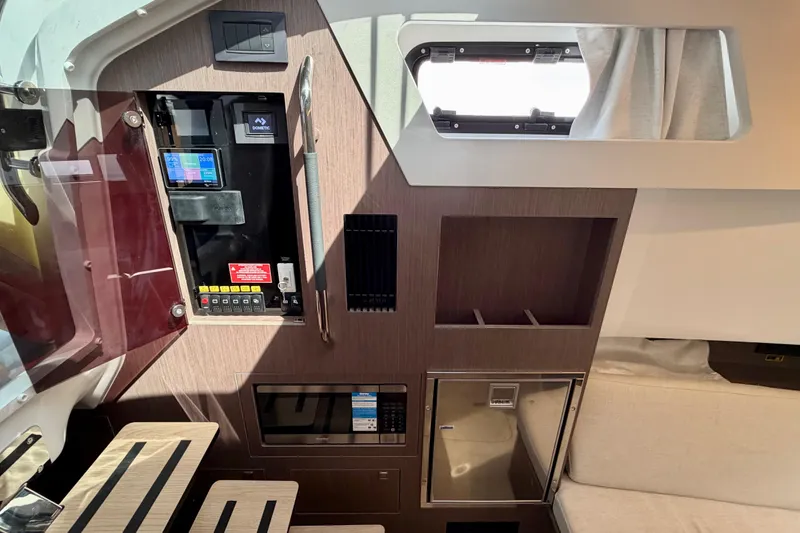 Slide: The Image of Interior of 2026 Beneteau Gran Turismo 35 yacht, featuring control panel and modern amenities. - 29