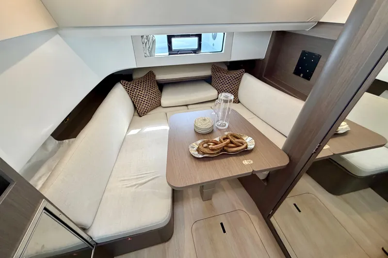 Slide: The Image of Interior of 2026 Beneteau Gran Turismo 35 yacht with cozy seating and elegant table setting. - 30