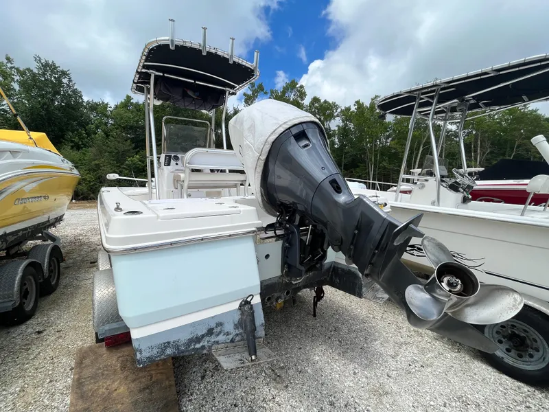 Slide: The Image of 2016 Robalo 206 Cayman boat with outboard motor, parked on gravel lot. - 10