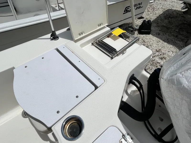 Slide: The Image of 2016 Robalo 206 Cayman boat deck with storage compartments and ladder. - 15