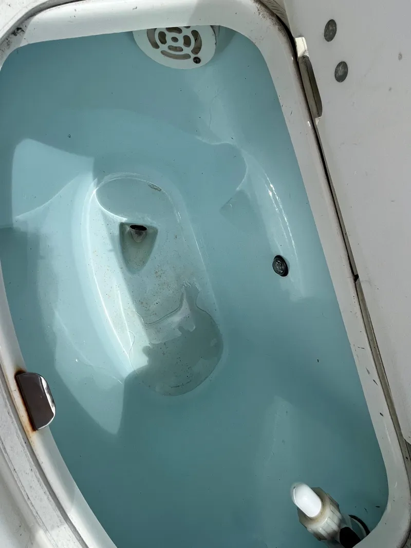 Slide: The Image of Livewell compartment in a 2016 Robalo 206 Cayman boat, showing interior details. - 17