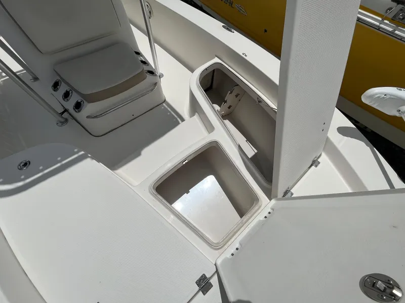 Slide: The Image of 2016 Robalo 206 Cayman boat storage compartments and seating area. - 32