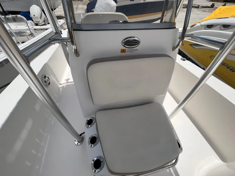 Slide: The Image of 2016 Robalo 206 Cayman boat interior with cushioned seating and stainless steel railings. - 33