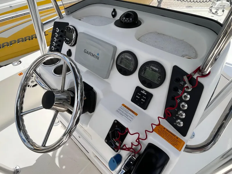 Slide: The Image of 2016 Robalo 206 Cayman boat dashboard with Garmin navigation and steering wheel. - 35