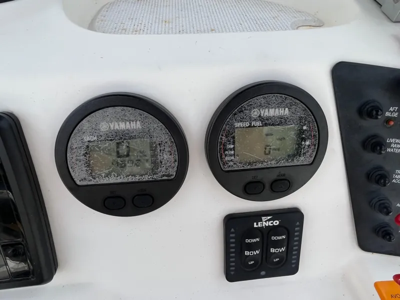 Slide: The Image of Yamaha gauges and Lenco controls on a 2016 Robalo 206 Cayman boat dashboard. - 36