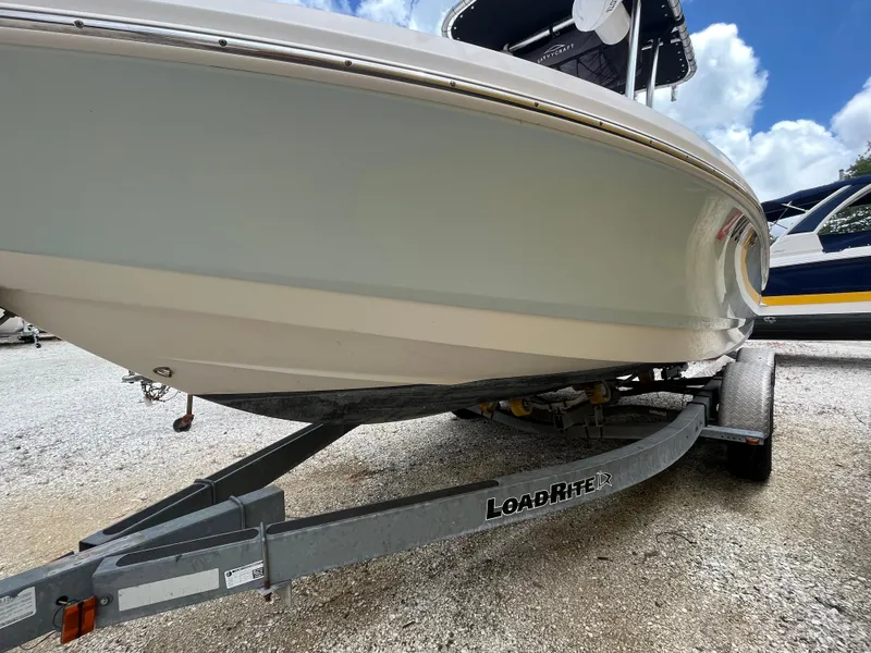 Slide: The Image of 2016 Robalo 206 Cayman boat on Load Rite trailer, parked outdoors. - 4