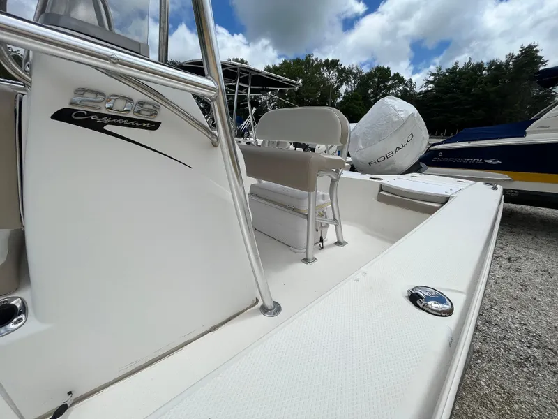 Slide: The Image of 2016 Robalo 206 Cayman boat with seating and outboard motor, under a cloudy sky. - 6