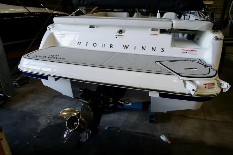 Slide: The Image of 2026 Four Winns H1 boat rear view with propeller and swim platform. - 11