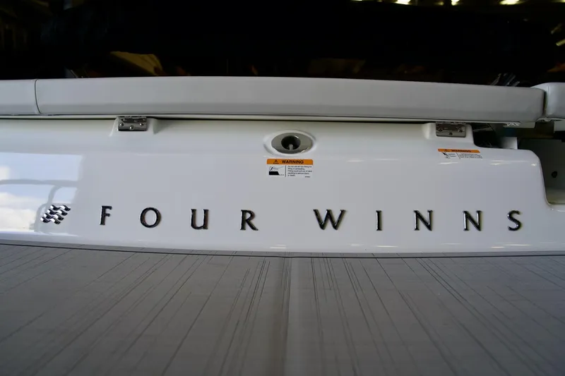 Slide: The Image of 2026 Four Winns H1 boat rear view with logo and warning labels. - 16