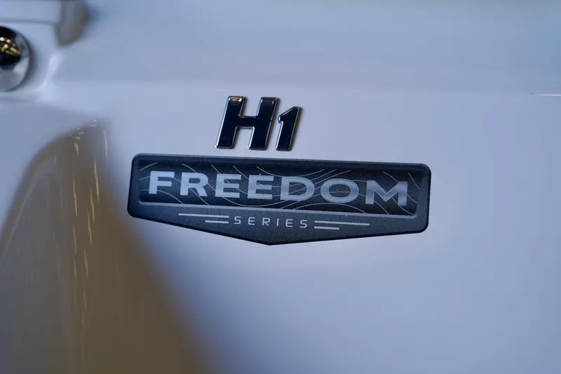 Slide: The Image of 2026 Four Winns H1 Freedom Series logo on boat exterior. - 17