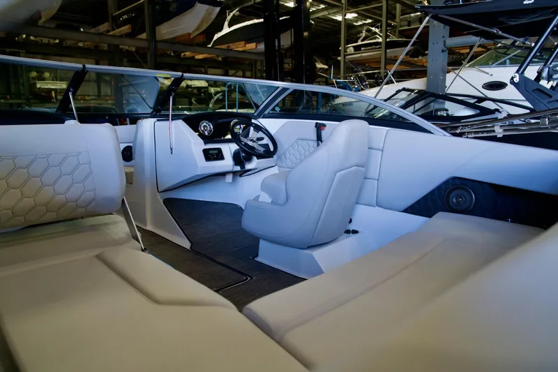 Slide: The Image of Interior of 2026 Four Winns H1 boat with modern white seating and steering wheel. - 5