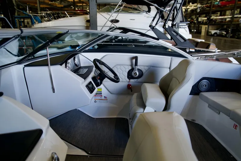 Slide: The Image of Interior of 2026 Four Winns H1 boat, featuring modern steering and seating. - 6